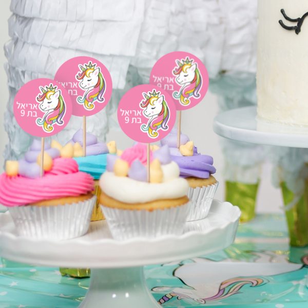 Little girl birthday party table with unicorn cake, cupcakes, and sugaer cookies.